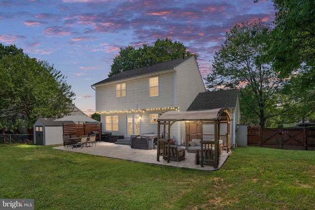 5008 Blake Dr, Fredericksburg, VA 22407 - back of property at dusk with a patio area, a shed, a fenced backyard, a pergola, and an outdoor living space