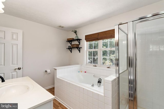 5008 Blake Dr, Fredericksburg, VA 22407 - full bath featuring wood finished floors, a garden tub, a shower stall, and vanity