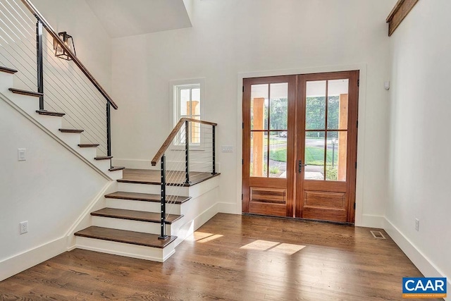 entryway featuring wood finished floors, french doors, stairway, baseboards, and visible vents