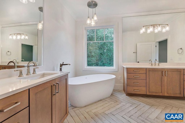 full bath featuring a soaking tub, two vanities, and a sink
