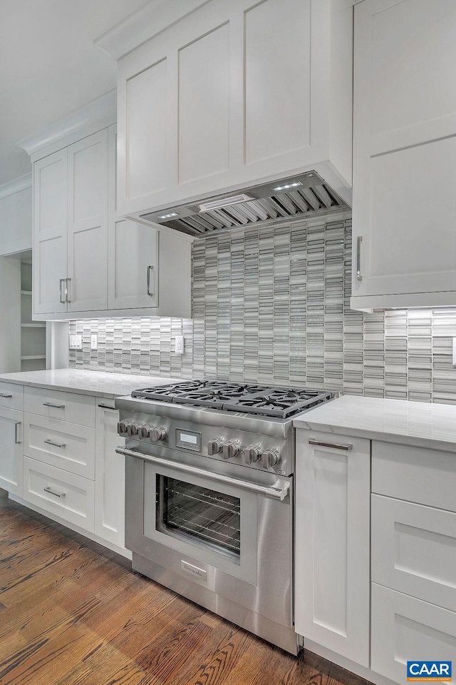 kitchen with white cabinets, decorative backsplash, and high end range