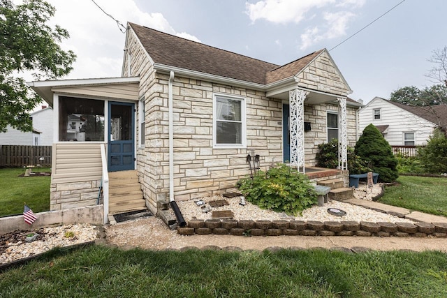310 Spotswood Ave E, Elkton, VA 22827 - view of front of house with stone siding, roof with shingles, and a sunroom