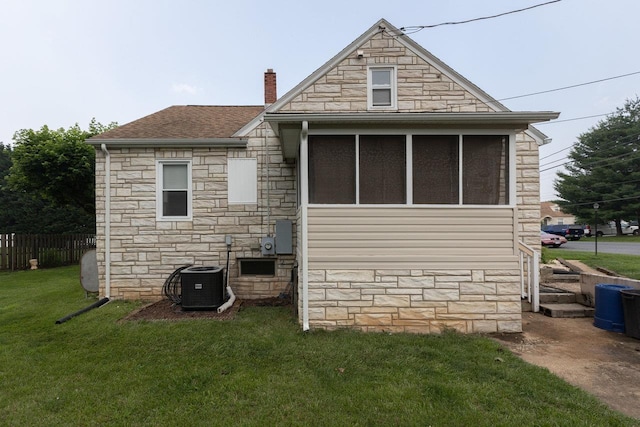 310 Spotswood Ave E, Elkton, VA 22827 - rear view of property with stone siding, a chimney, central AC, a sunroom, and a shingled roof