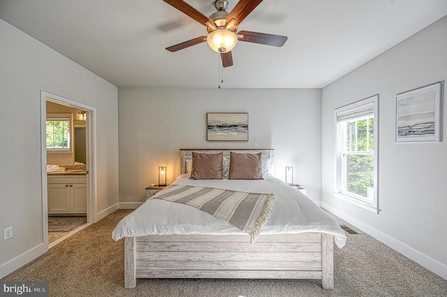 5220 Wyndemere Cir, Mineral, VA 23117 - carpeted bedroom featuring multiple windows, baseboards, connected bathroom, and a ceiling fan