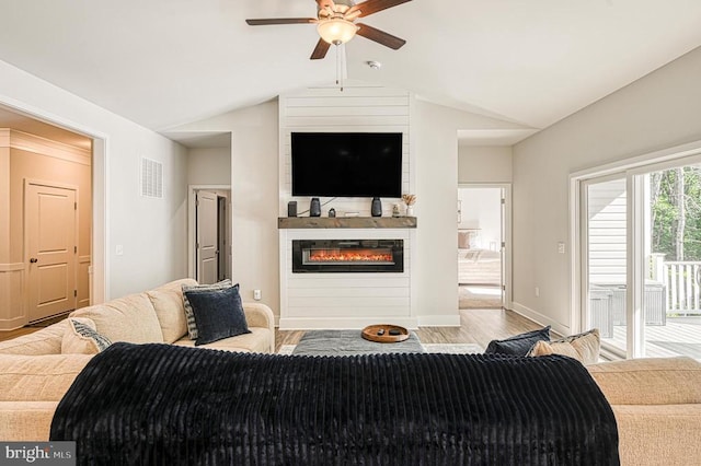 5220 Wyndemere Cir, Mineral, VA 23117 - living area with ceiling fan, wood finished floors, a glass covered fireplace, lofted ceiling, and baseboards