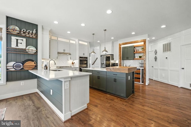 10901 Brandermill Park, Spotsylvania, VA 22551 - kitchen featuring appliances with stainless steel finishes, tasteful backsplash, dark wood finished floors, recessed lighting, and a peninsula