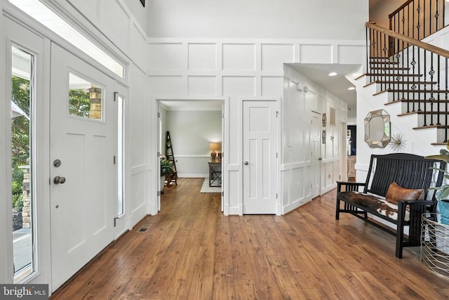 10901 Brandermill Park, Spotsylvania, VA 22551 - entryway featuring a decorative wall, wood-type flooring, stairs, and a towering ceiling
