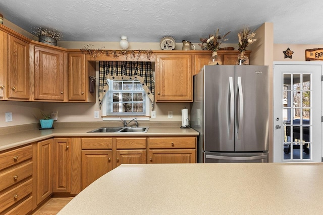 18785 Red Brush Rd, Elkton, VA 22827 - kitchen featuring freestanding refrigerator, light countertops, brown cabinetry, and a sink