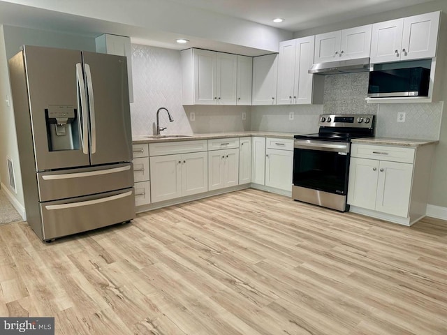 11506 Light Ln, Spotsylvania, VA 22551 - kitchen with stainless steel appliances, under cabinet range hood, a sink, light countertops, and recessed lighting