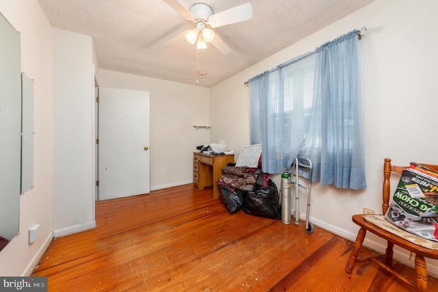 234 Landon Ln, Orange, VA 22960 - misc room with wood finished floors, a textured ceiling, a ceiling fan, and baseboards