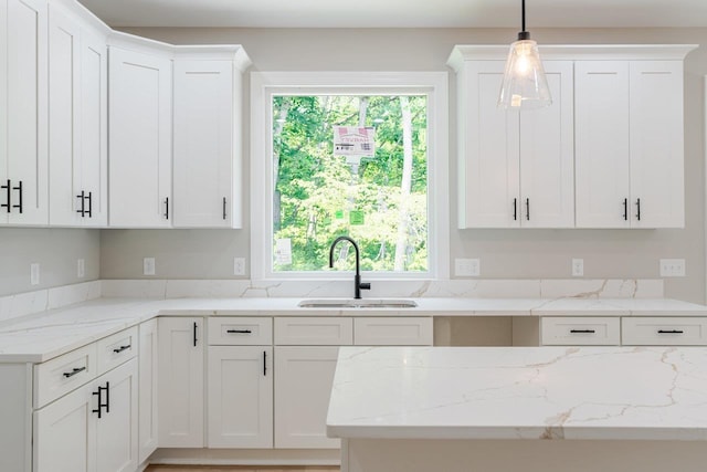 4125 Romney Ct, Rockingham, VA 22802 - kitchen with healthy amount of natural light, white cabinets, and light stone counters