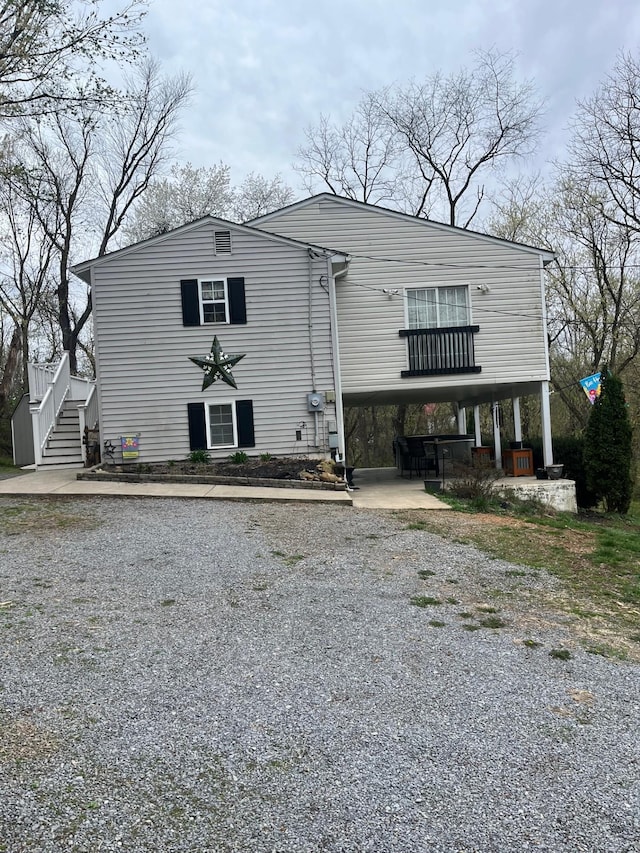 290 Shenandoah River Rd, Shenandoah, VA 22849 - back of house featuring a carport, stairway, and gravel driveway