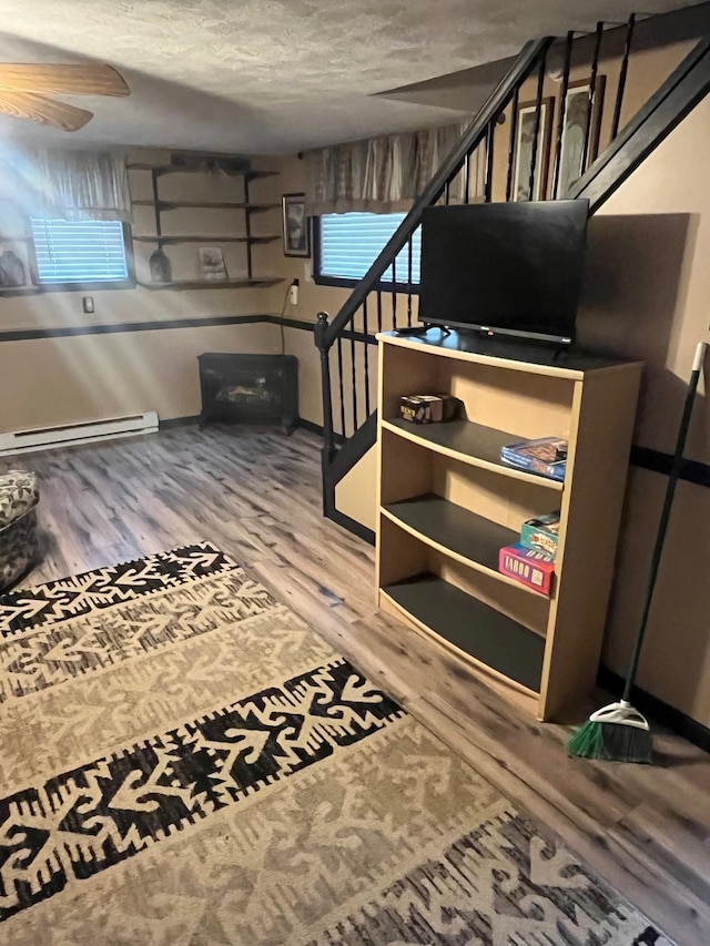 290 Shenandoah River Rd, Shenandoah, VA 22849 - stairway with a textured ceiling, wood finished floors, and a baseboard radiator