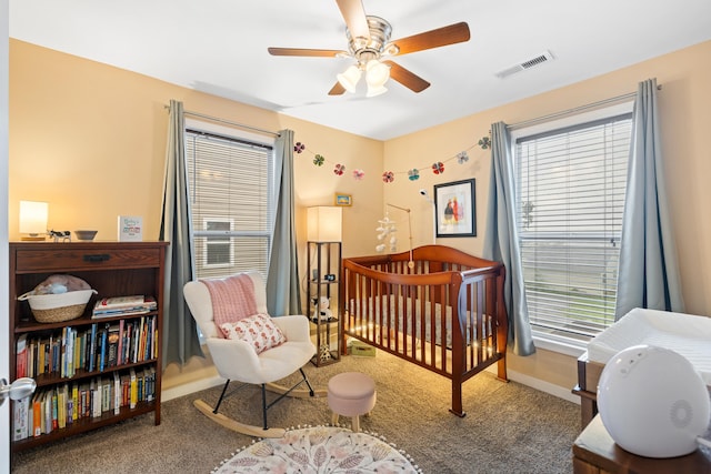 832 Grayson Ave, Waynesboro, VA 22980 - carpeted bedroom with a crib, multiple windows, and a ceiling fan