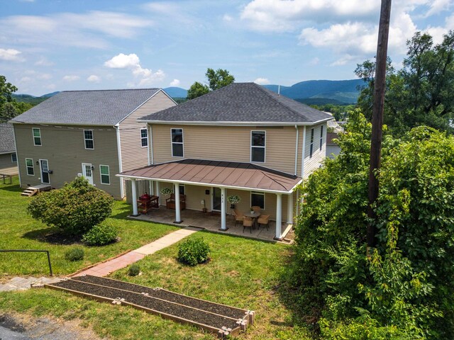 832 Grayson Ave, Waynesboro, VA 22980 - rear view of property with a yard, a mountain view, a standing seam roof, a shingled roof, and covered porch
