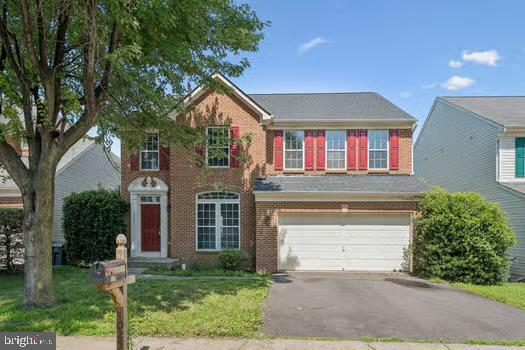 1025 Riverdale Cir, Culpeper, VA 22701 - view of front of house with a garage, brick siding, asphalt driveway, and a front lawn
