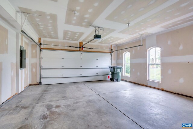 garage with electric panel and a garage door opener
