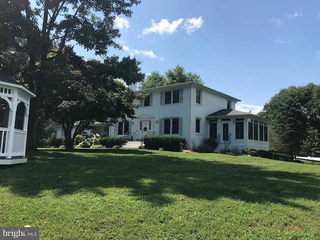 409 Cook Mountain Dr, Brightwood, VA 22715 - back of house with a sunroom, a lawn, and stucco siding