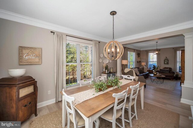11001 Waterstone Pl, Spotsylvania, VA 22551 - dining space with a chandelier, crown molding, light wood-style floors, and healthy amount of natural light