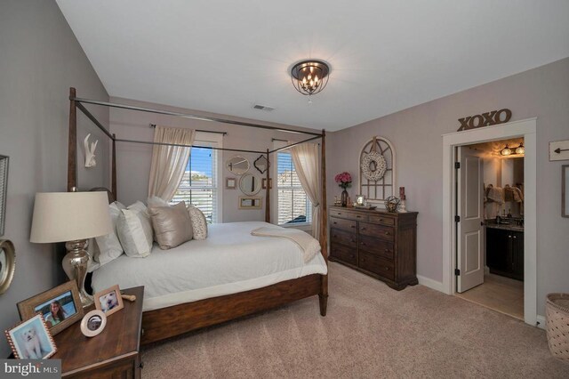 11001 Waterstone Pl, Spotsylvania, VA 22551 - carpeted bedroom with a chandelier, baseboards, and ensuite bath