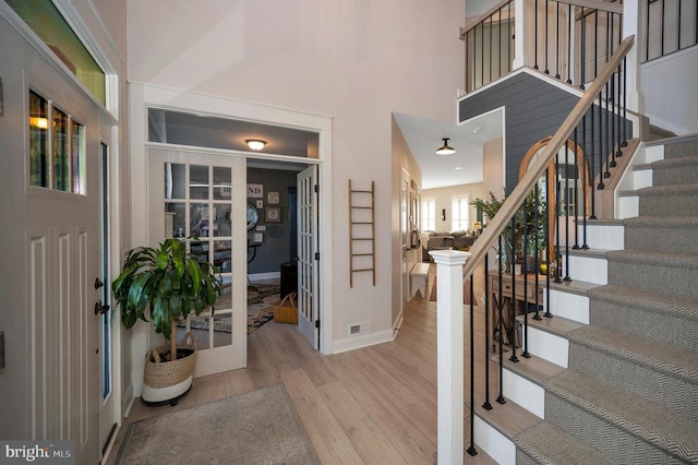 11001 Waterstone Pl, Spotsylvania, VA 22551 - entrance foyer with wood finished floors, stairway, baseboards, and a towering ceiling