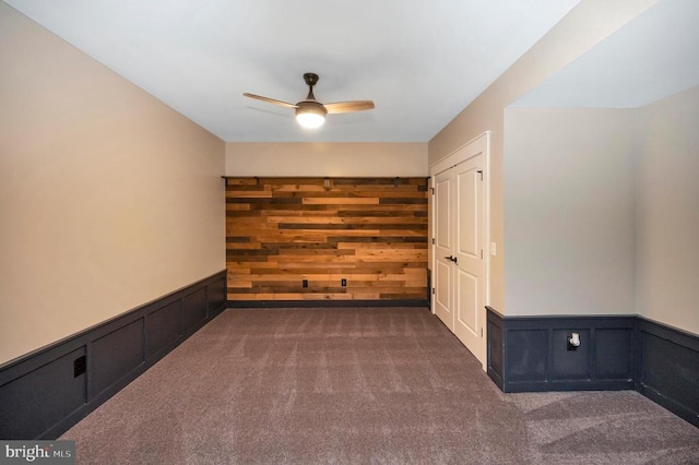 11001 Waterstone Pl, Spotsylvania, VA 22551 - carpeted spare room featuring a ceiling fan, wainscoting, and wood walls