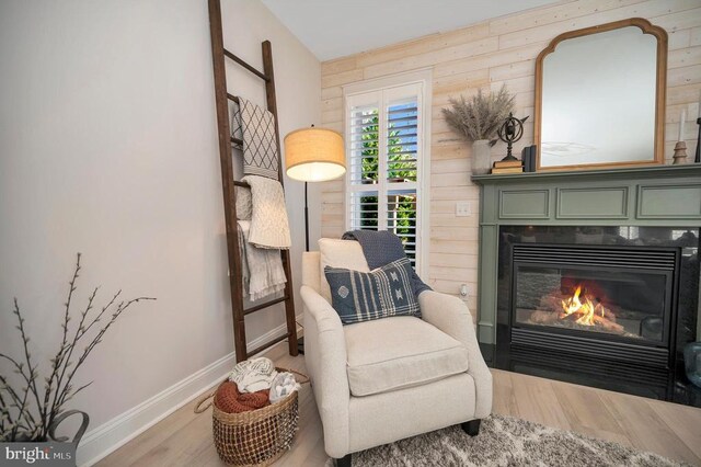 11001 Waterstone Pl, Spotsylvania, VA 22551 - sitting room with wood finished floors, baseboards, and a glass covered fireplace
