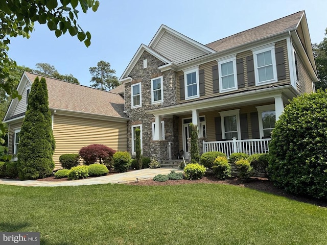 11001 Waterstone Pl, Spotsylvania, VA 22551 - craftsman-style home with covered porch, a front lawn, and stone siding