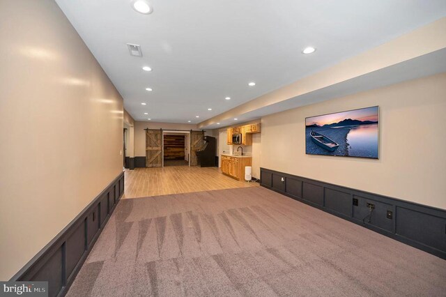11001 Waterstone Pl, Spotsylvania, VA 22551 - corridor featuring recessed lighting, a sink, light colored carpet, and light wood-style flooring