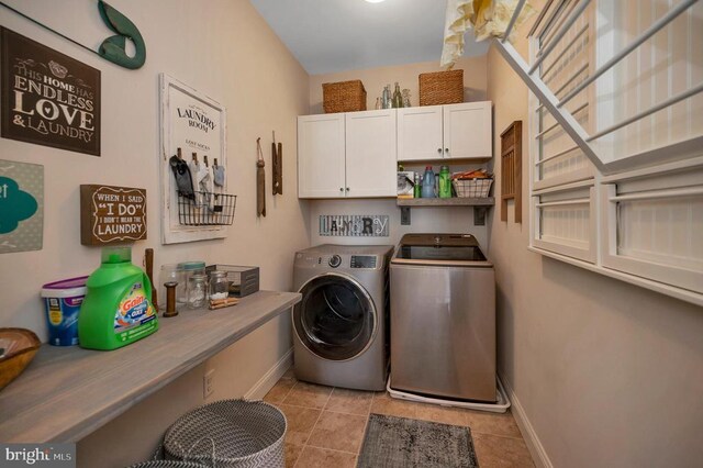 11001 Waterstone Pl, Spotsylvania, VA 22551 - laundry area with washing machine and dryer, cabinet space, baseboards, and light tile patterned floors