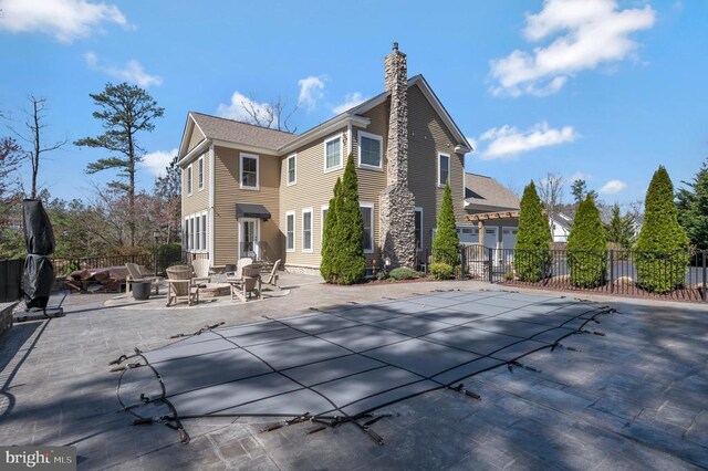 11001 Waterstone Pl, Spotsylvania, VA 22551 - rear view of property featuring a chimney and a patio area