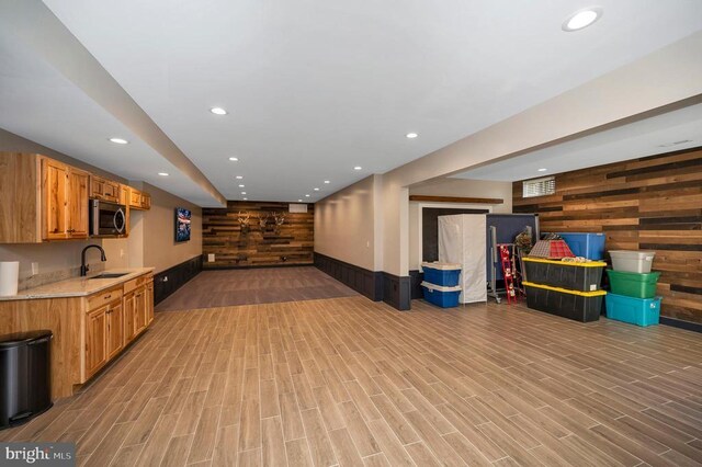11001 Waterstone Pl, Spotsylvania, VA 22551 - finished below grade area featuring a sink, wood walls, recessed lighting, and light wood-style floors