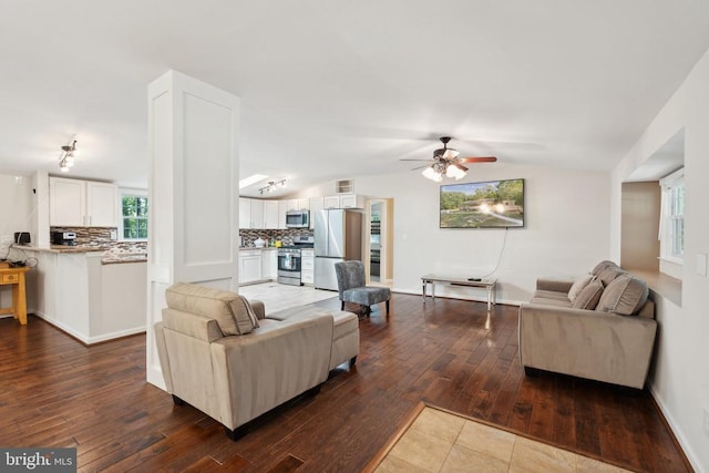31055 Lumber Rd, Locust Grove, VA 22508 - living area featuring a ceiling fan, dark wood-style flooring, vaulted ceiling, and baseboards