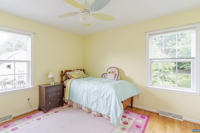 5031 Clearfields Ct, Crozet, VA 22932 - bedroom with multiple windows, wood finished floors, and ceiling fan
