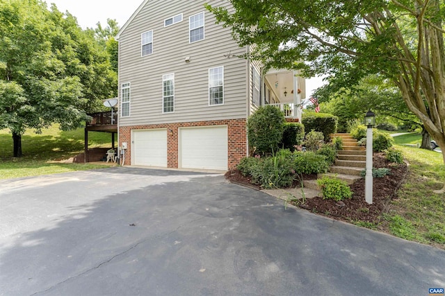 5031 Clearfields Ct, Crozet, VA 22932 - view of property exterior featuring driveway, an attached garage, brick siding, and stairs