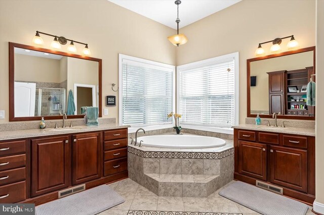 7610 Downstream Ct, Fredericksburg, VA 22408 - bathroom featuring two vanities, a shower stall, a garden tub, and tile patterned floors