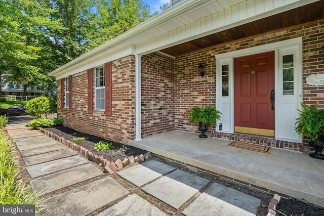  - view of exterior entry featuring brick siding