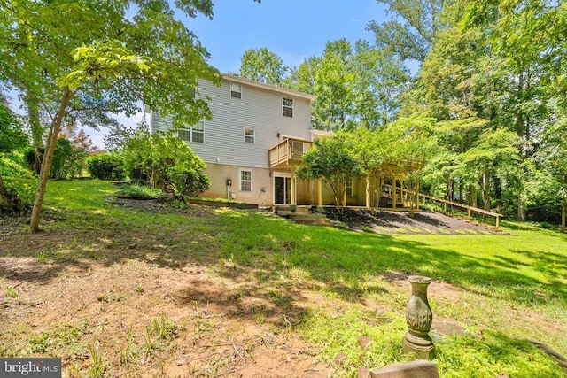  - back of house with a lawn and a wooden deck
