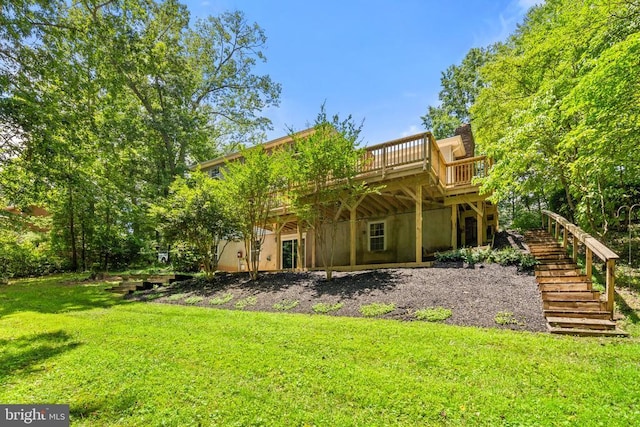  - back of property featuring a yard, stairway, and a deck