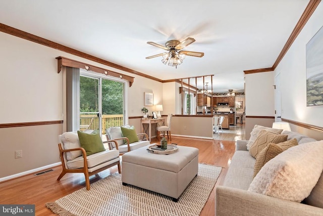  - living room with ornamental molding, light wood-style flooring, and ceiling fan
