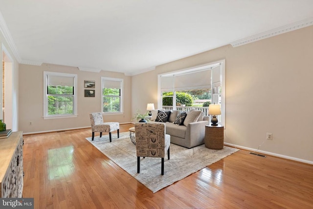 - living room with light wood finished floors and crown molding