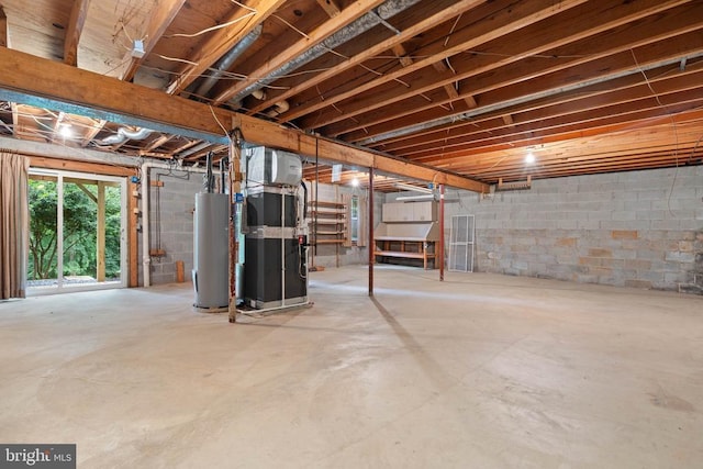  - below grade area featuring water heater, heating unit, and concrete block wall
