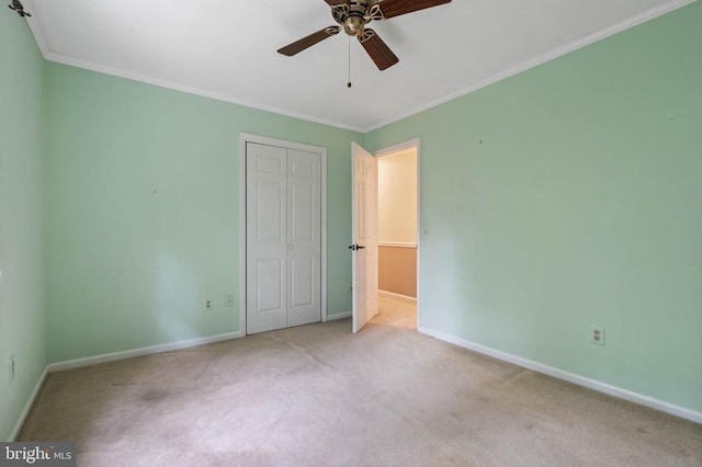  - unfurnished bedroom with carpet floors, a closet, ornamental molding, and ceiling fan