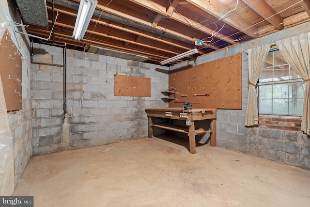 - unfinished basement with a workshop area
