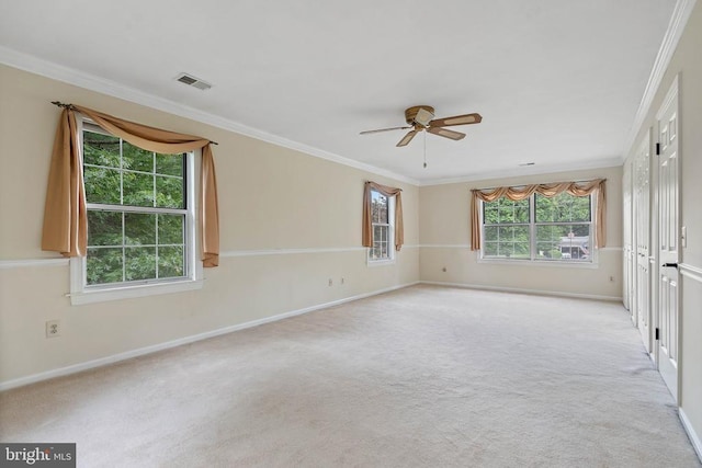  - empty room with ceiling fan, ornamental molding, and light carpet