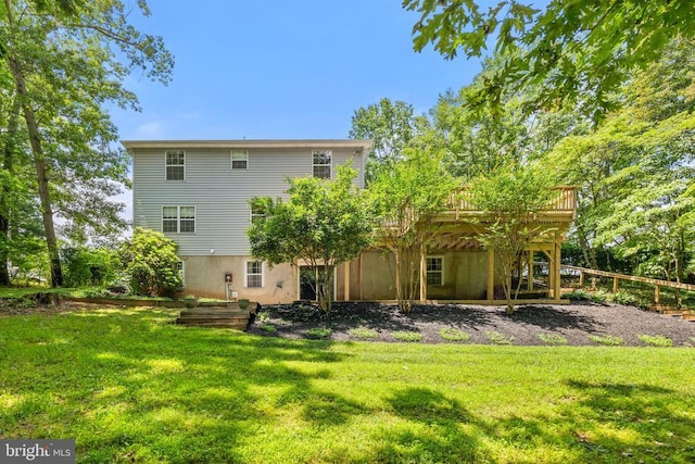 - rear view of property with a deck and a yard