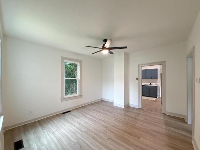 1203 Walnut St, Staunton, VA 24401 - unfurnished bedroom featuring light wood-style flooring, baseboards, a ceiling fan, and a sink
