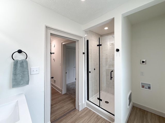 1203 Walnut St, Staunton, VA 24401 - full bathroom featuring wood finished floors, a shower stall, a sink, baseboards, and recessed lighting