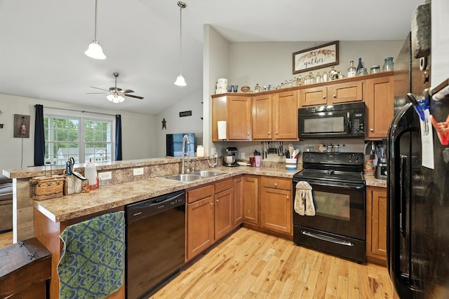 14975 Woodcreek Ln, Timberville, VA 22853 - kitchen featuring black appliances, vaulted ceiling, a peninsula, light wood-style floors, and brown cabinetry