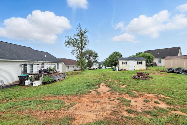 14975 Woodcreek Ln, Timberville, VA 22853 - view of green lawn with an outdoor fire pit, a deck, and a shed